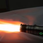 Activated,Lightsaber,Resting,On,Fabric.,Not,As,Clumsy,Or,Random